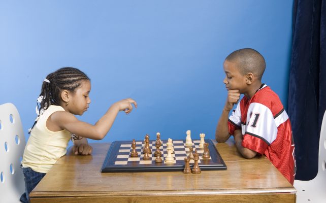 boy and girl playing chess